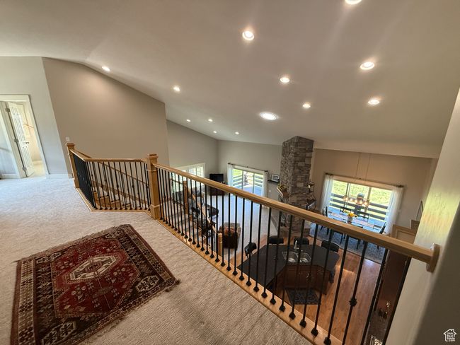 Hallway with an upstairs landing, recessed lighting, 19' vaulted ceiling, and brand new carpet; overlooking the mainfloor great room and kitchen. | Image 15