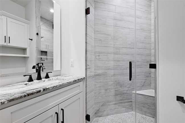 Full bath featuring a stall shower and vanity | Image 24