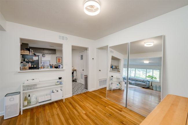 Living room with wood-type flooring and baseboards | Image 14