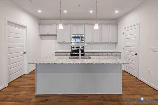 You'll love gathering with loved ones around this spacious center island! HOME IS UNDER CONSTRUCTION - Photo is from builder's library and shown as an example only (colors, features and options will vary). | Image 8