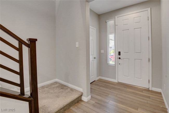 Foyer featuring light wood-style flooring, baseboards, and stairway | Image 5