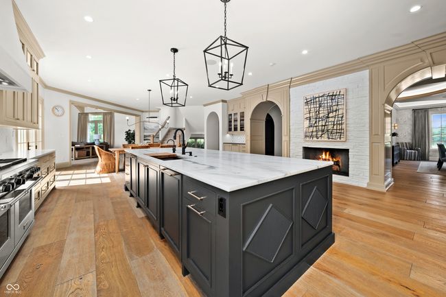 kitchen featuring arched walkways, Fireplace and open to the Breakfast Area and Hearth Room | Image 17