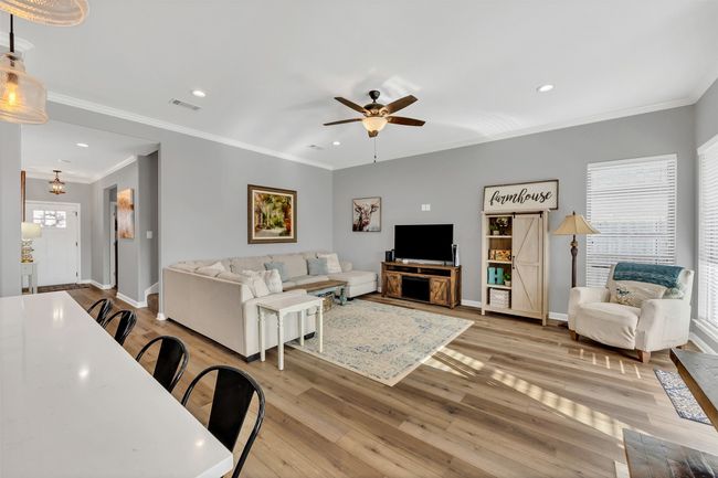 Living room with recessed lighting, visible vents, baseboards, and light wood finished floors | Image 10