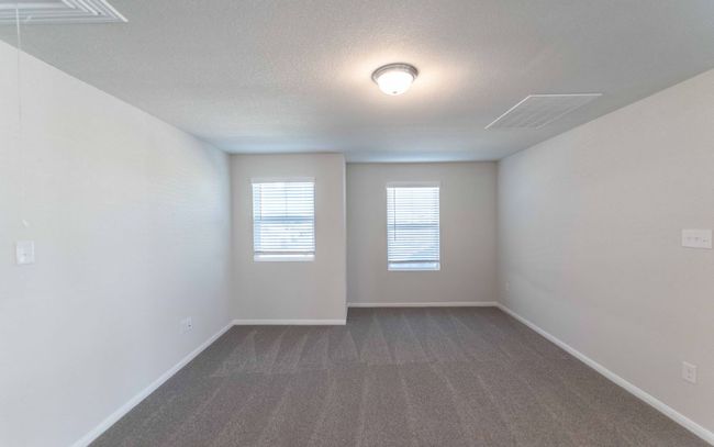 Spare room featuring dark carpet, a textured ceiling, and attic access | Image 15