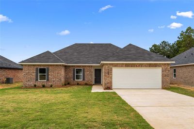 Ranch-style house with a garage, a front yard, and central AC unit | Image 1