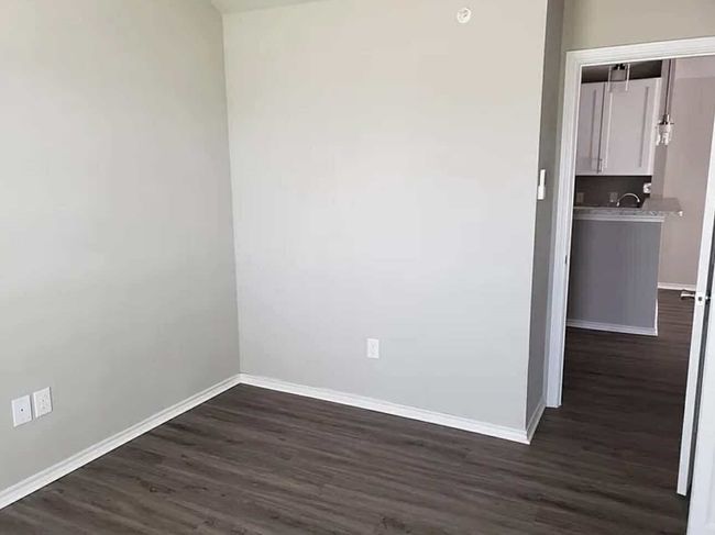 Unfurnished room featuring dark wood finished floors and baseboards | Image 9