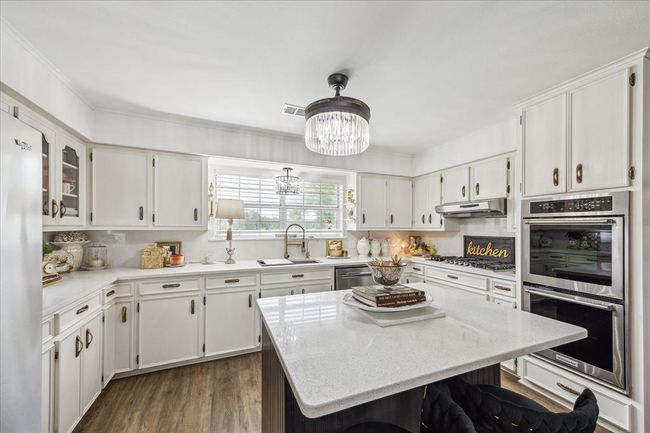 Kitchen with stainless steel appliances and new countertops | Image 15
