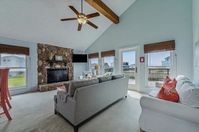 The home is filled with natural light, tall ceiling, rustic stained beam. Open floor plan with patio door to large deck facing the Gulf. Enjoy these views from your patio deck every day! | Image 3