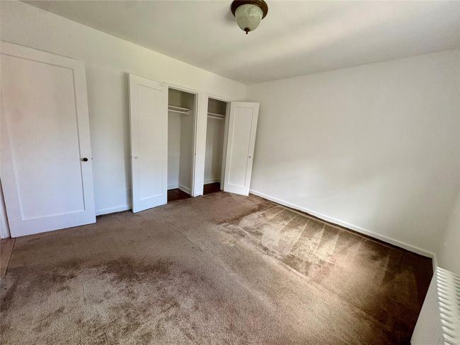 Unfurnished bedroom with carpet floors and a closet | Image 7