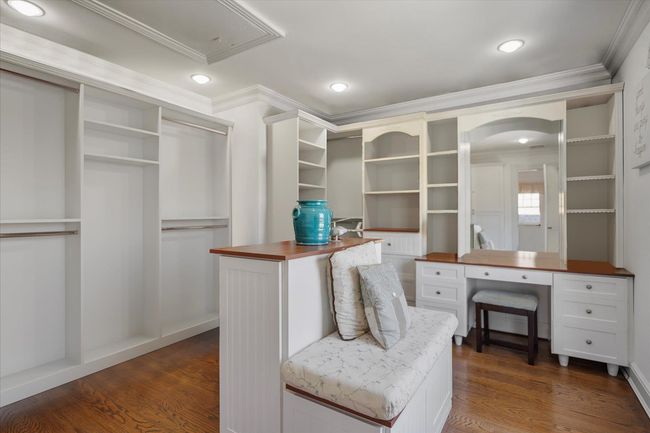 Spacious closet with attic access, arched walkways, and dark wood-style flooring | Image 33