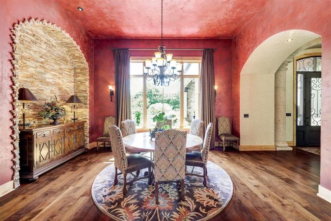Right off the main entrance, the formal dining room has a built in stone nook and oversized windows that look to the front yard. | Image 8