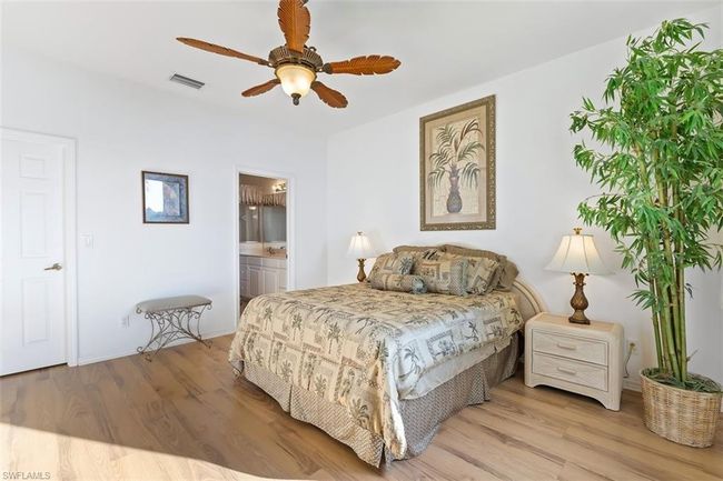 Bedroom featuring ceiling fan, connected bathroom, and light hardwood / wood-style flooring | Image 17