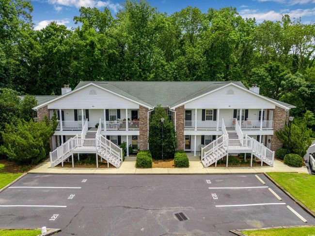 View of building exterior featuring stairway and uncovered parking | Image 30