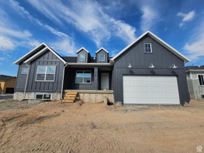 View of front facade with a garage and covered porch | Image 1