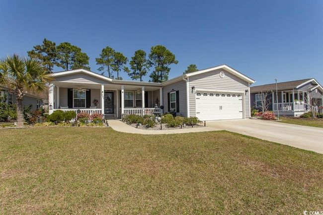 Single story home with a front lawn, covered porch, concrete driveway, and an attached garage | Image 40