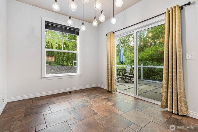 Ample space for a 4-6 person dining table. Step out the sliding doors to the private patio and new deck. You can hear the creek in the protected wetland behind the house. | Image 7