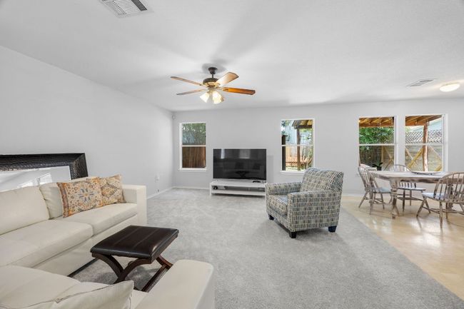 The living room is open to the dining area and kitchen. | Image 5
