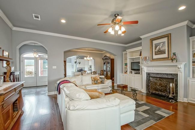 Arched doorways/walls open to foyer and Dining Room & kitchen. Perfect for entertaining! | Image 9