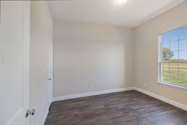 Empty room featuring baseboards and dark wood-style floors | Image 19