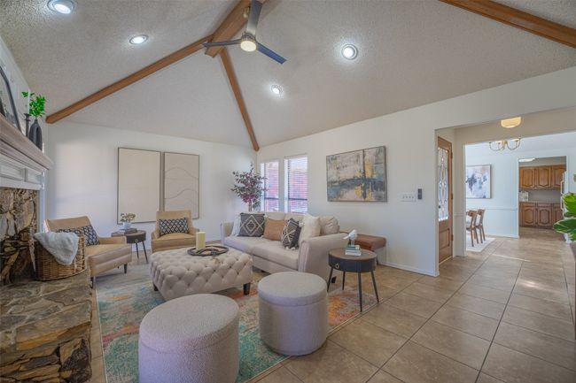Living area with a view of the front entry, dining and kitchen | Image 8