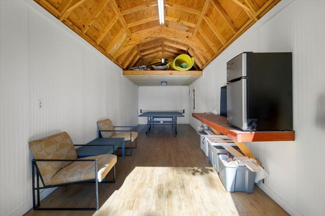 Living area featuring wood finished floors and vaulted ceiling | Image 31