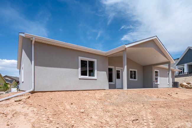 Back of property featuring stucco siding and central air condition unit | Image 49