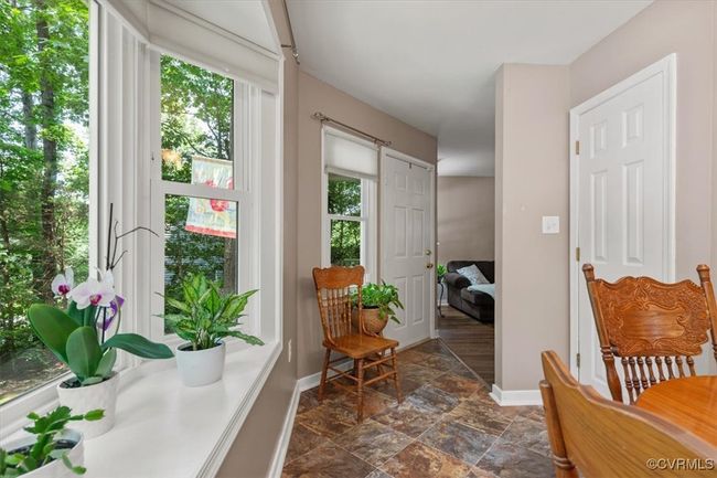 Doorway with baseboards, plenty of natural light, and stone finish flooring | Image 20