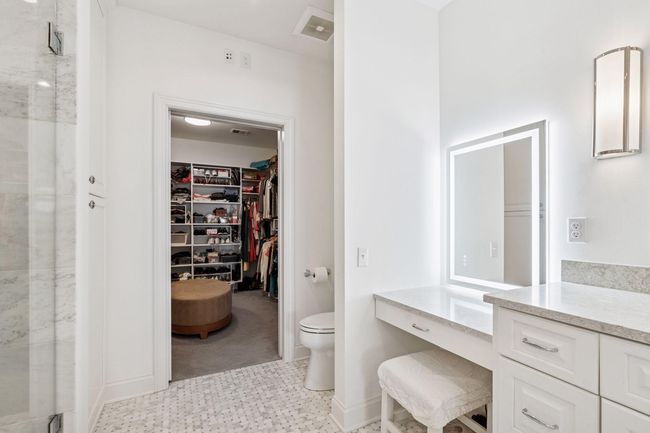 Additional highlights include lighted vanity area and large walk-in closet with built-in organizational components | Image 20