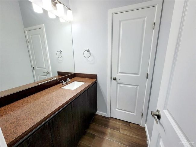 Bathroom with vanity, baseboards, and wood finish floors | Image 15