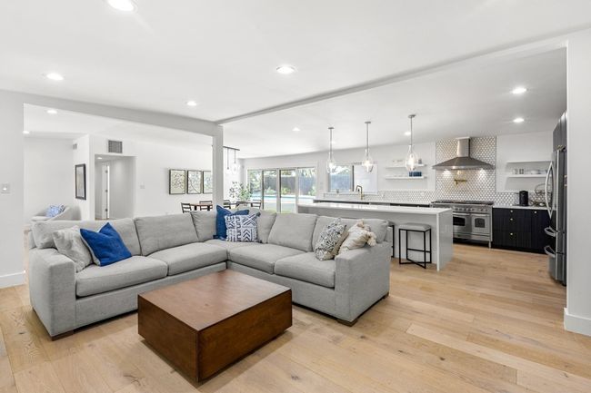 Living room with light wood-type flooring, visible vents, and recessed lighting | Image 13