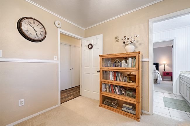 Hallway featuring light carpet and ornamental molding | Image 28