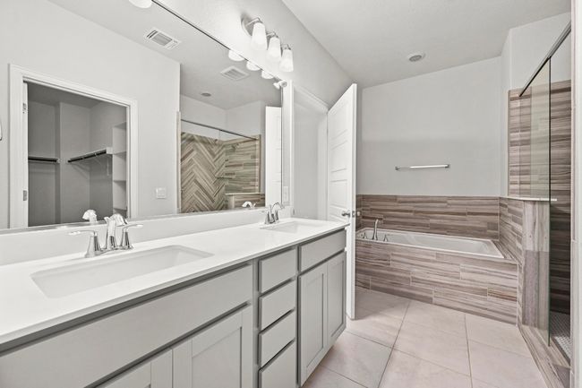 Full bathroom with a bath, a stall shower, double vanity, tile patterned flooring, and a spacious closet | Image 24