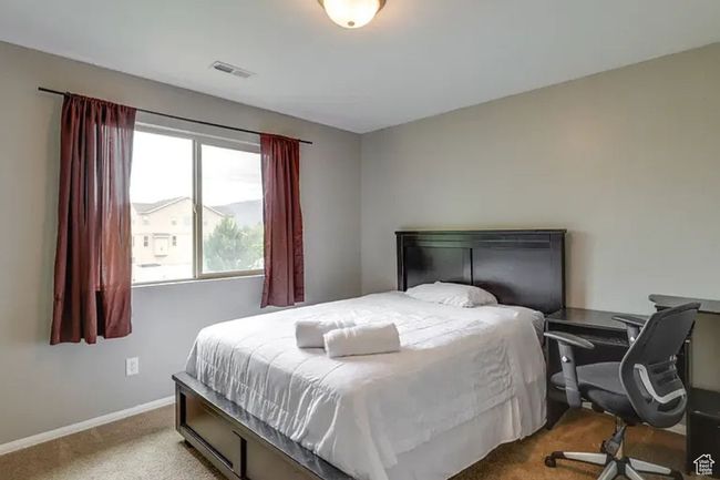 Carpeted bedroom featuring baseboards and visible vents | Image 17