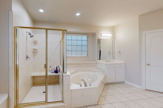 Bathroom with a shower stall, a garden tub, tile patterned floors, and vanity | Image 20