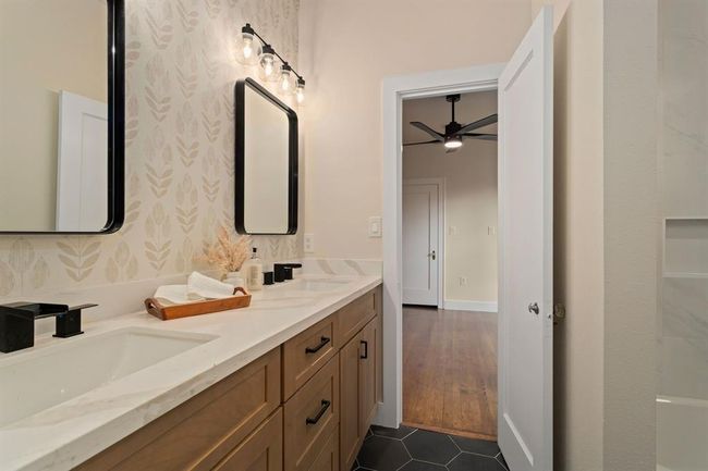 This spacious and luxurious Hollywood bathroom is shared between the second and third bedrooms; if offers stunning finishes including large hexagonal tile flooring. | Image 25