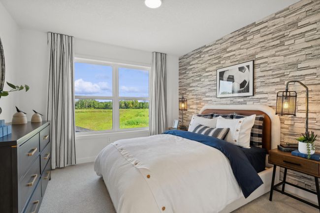 (Photo of a decorated model, actual homes finishes will vary) The third secondary bedroom on the upper level. | Image 19