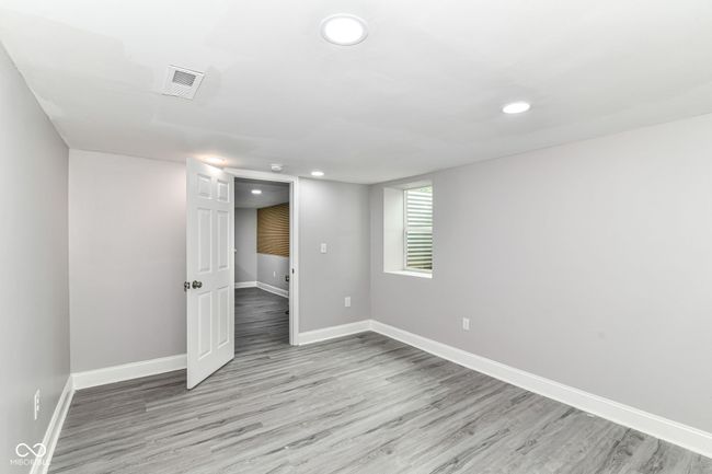 empty room with light wood finished floors, baseboards, and recessed lighting | Image 30