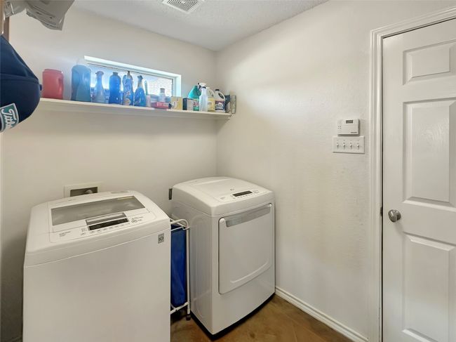 Washroom with washer and clothes dryer and a textured ceiling | Image 26