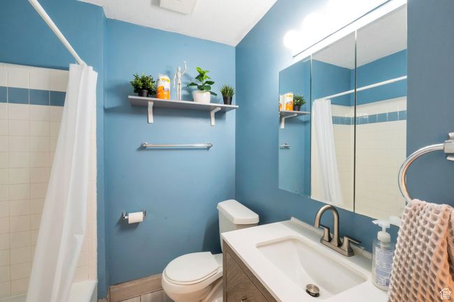 Bathroom featuring toilet and vanity | Image 8