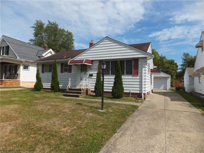 Bungalow-style home with a garage and a front lawn | Image 1