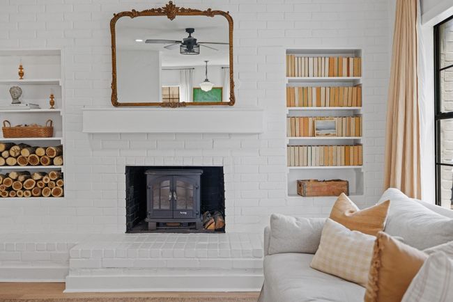 Living room with ceiling fan and built in features | Image 6