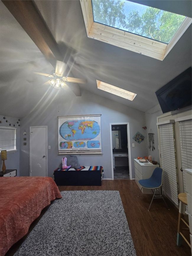 Bedroom with a skylight, lofted ceiling, wood finished floors, and a ceiling​​‌​​​​‌​​‌‌​‌‌​​​‌‌​​‌‌​‌​​​​​‌ fan | Image 12