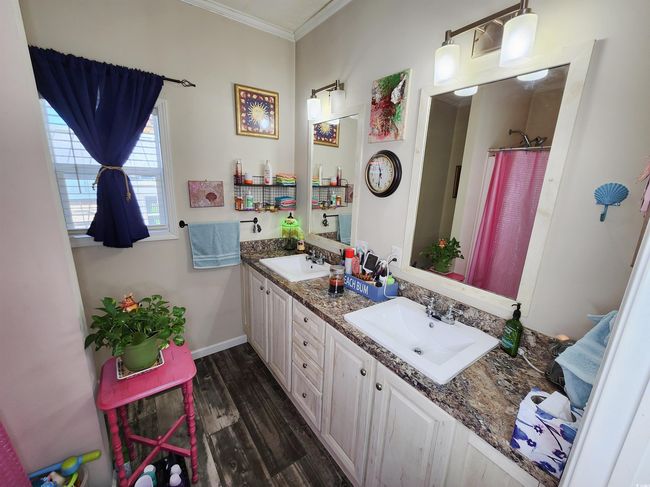 Bathroom with hardwood / wood-style floors, vanity, a shower with shower curtain, and ornamental molding | Image 16