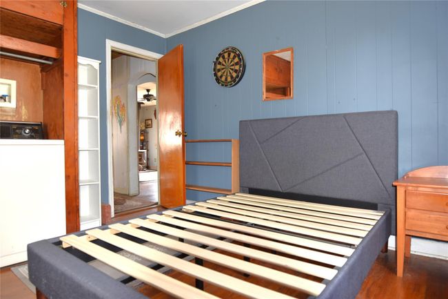 Bedroom featuring crown molding and wood finished floors | Image 10