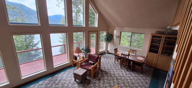 Living area with a mountain and water view | Image 25