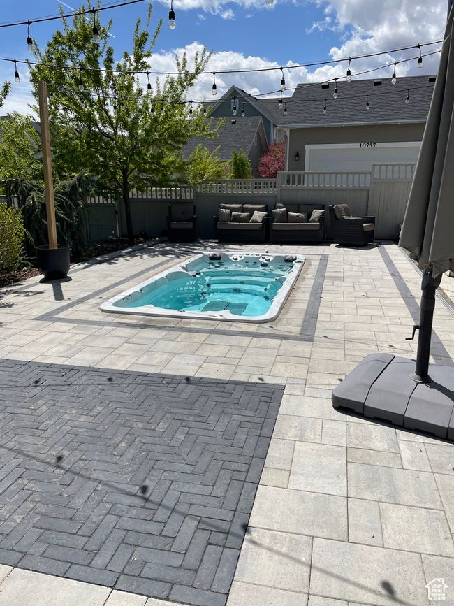 View of spa with fence, a patio area, and an outdoor hangout area | Image 75