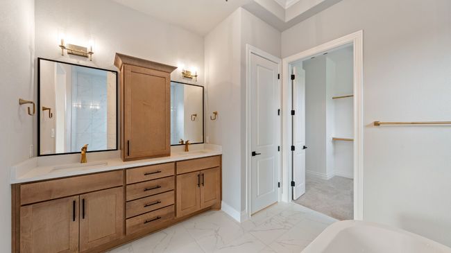 Full bath featuring a freestanding bath and light marble finish flooring | Image 26