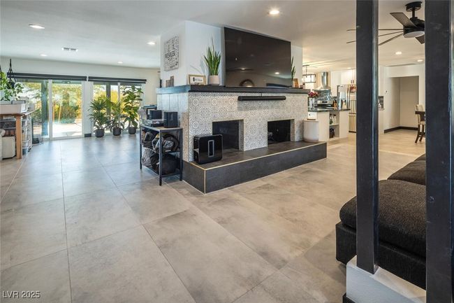 Living room featuring recessed lighting, visible vents, ceiling fan, and a fireplace | Image 6