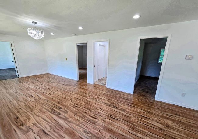 Living area doors to bedrooms and bath | Image 11