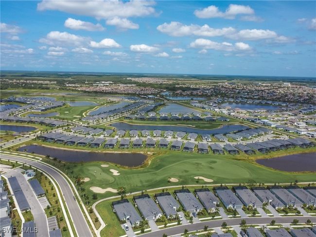 Aerial overview of property's location featuring nearby suburban area, a large body of water, and a local golf course | Image 37